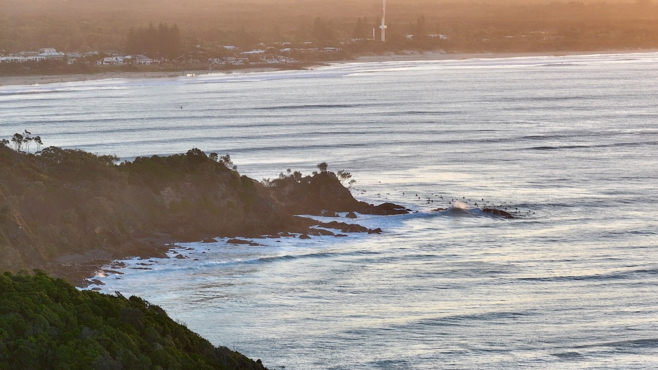Surfers waiting on the line-up at golden hour