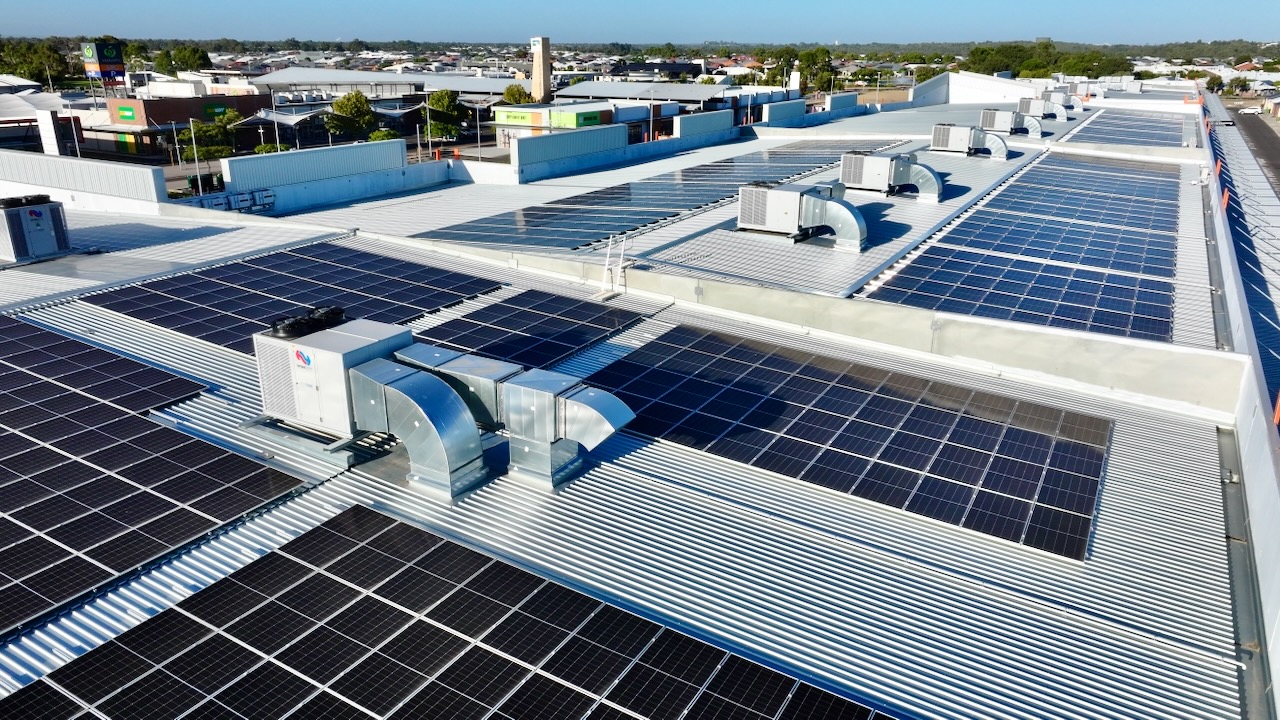 Aerial view of solar panels installed across a commercial rooftop