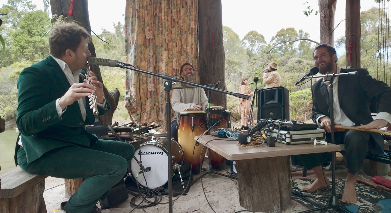 Outdoor recording session under tall trees